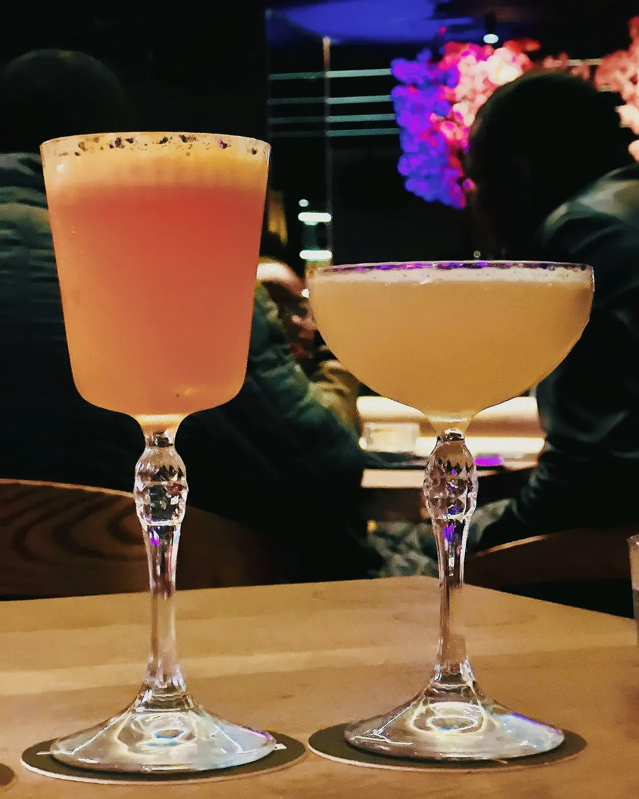 two cocktails standing on the bar