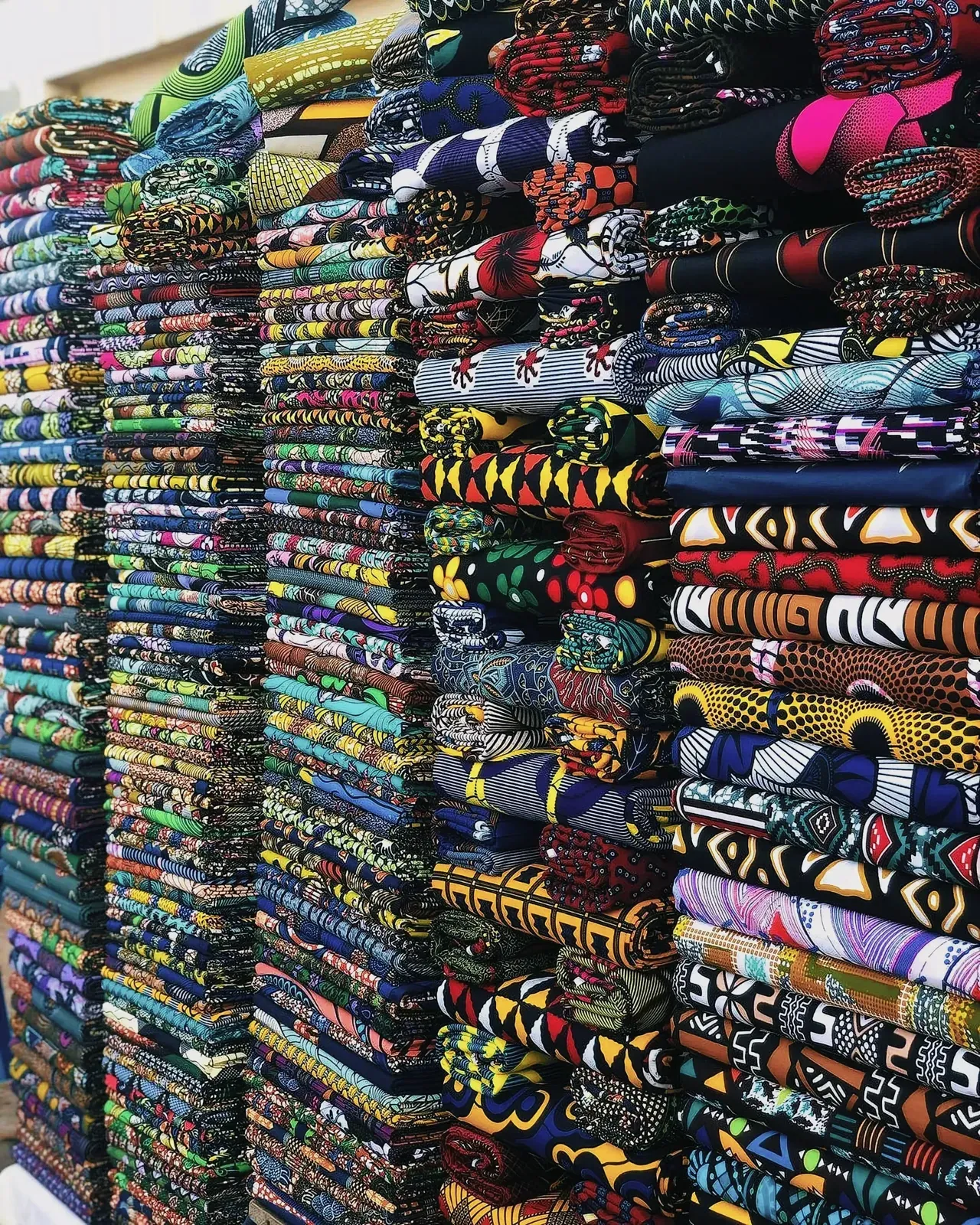 Colorful fabrics stacked neatly in a store in Lomé, Togo.
