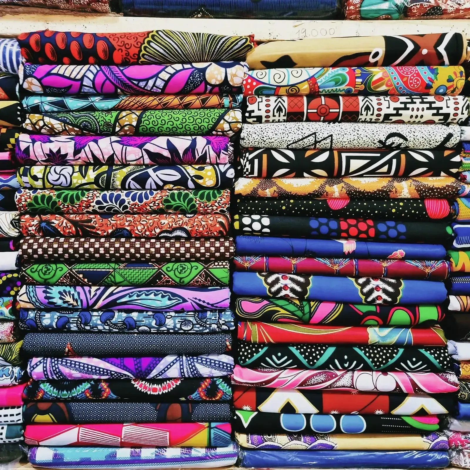 Assorted vibrant fabrics at a market in Lomé, Togo