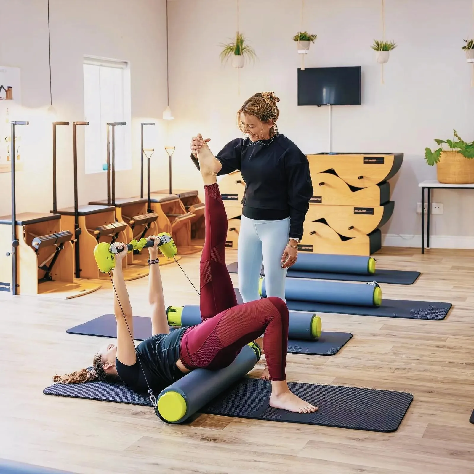 Two women engaging in a fitness session at Paarl Pilates studio.