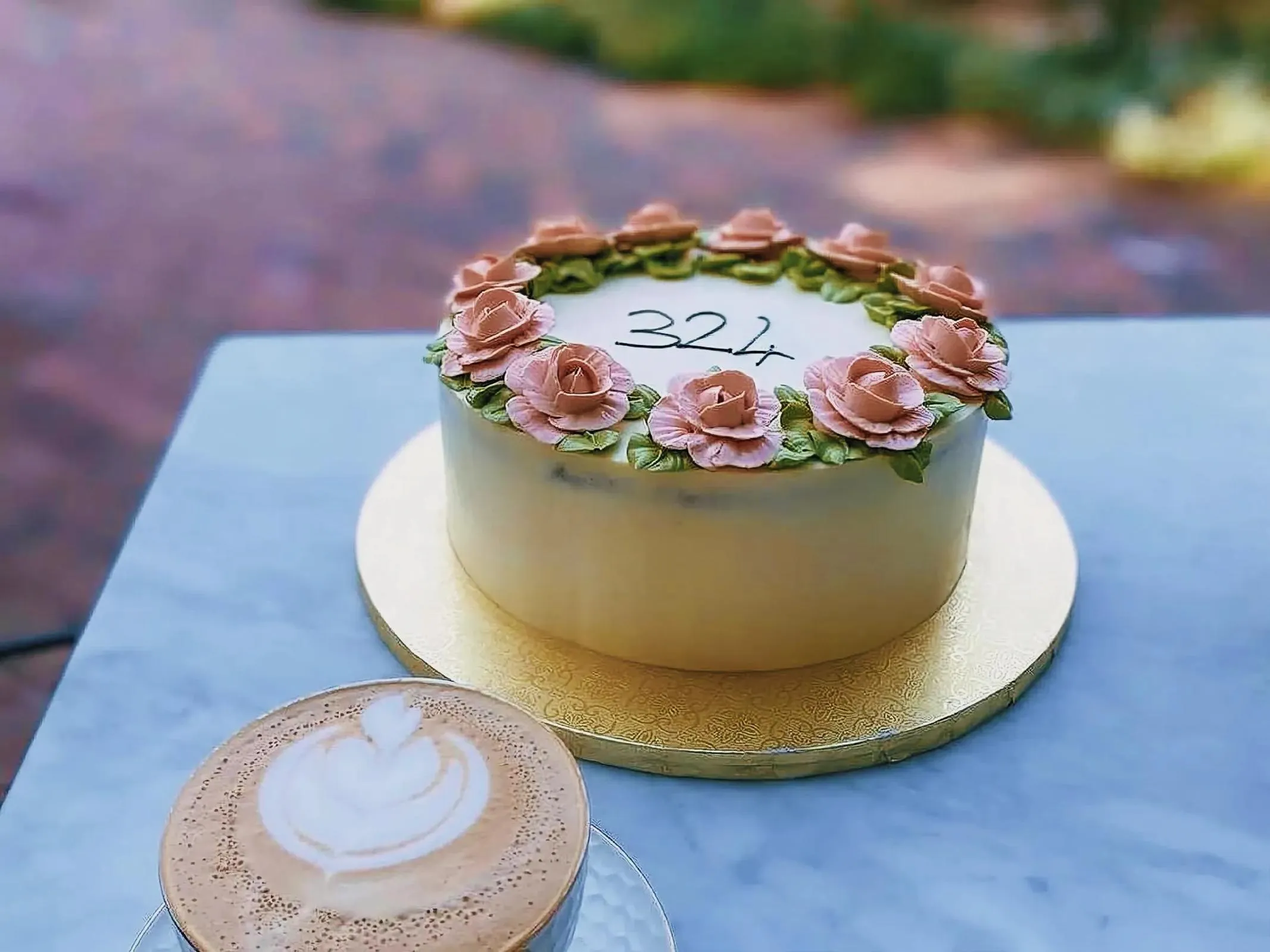 Beautifully decorated cake and latte with art on top